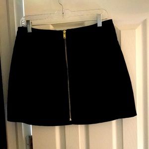 Black mini skirt. Size large. Full zipper in front of skirt.